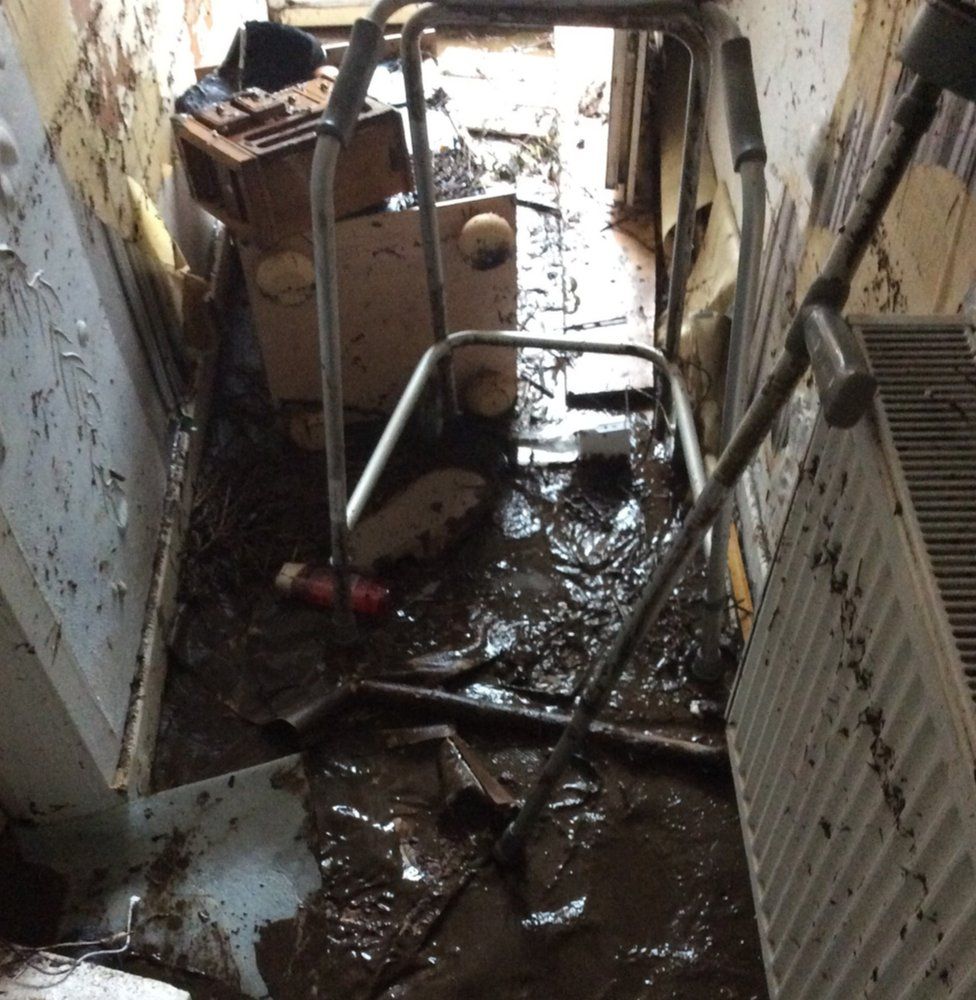 After the flood there was mud and debris left in Paul Thomas's hall