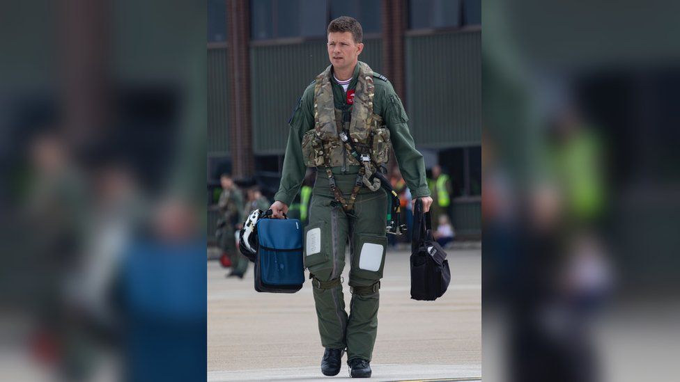 Squadron Leader Tom Bould walks out to his aircraft at RAF Waddington prior to take off