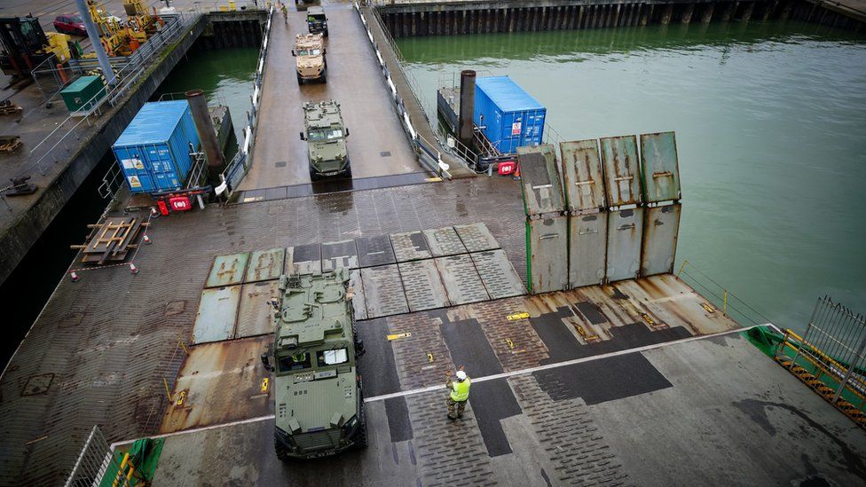 Military vehicles driving on to MV Anvil Point at the Sea Mounting Centre in Marchwood