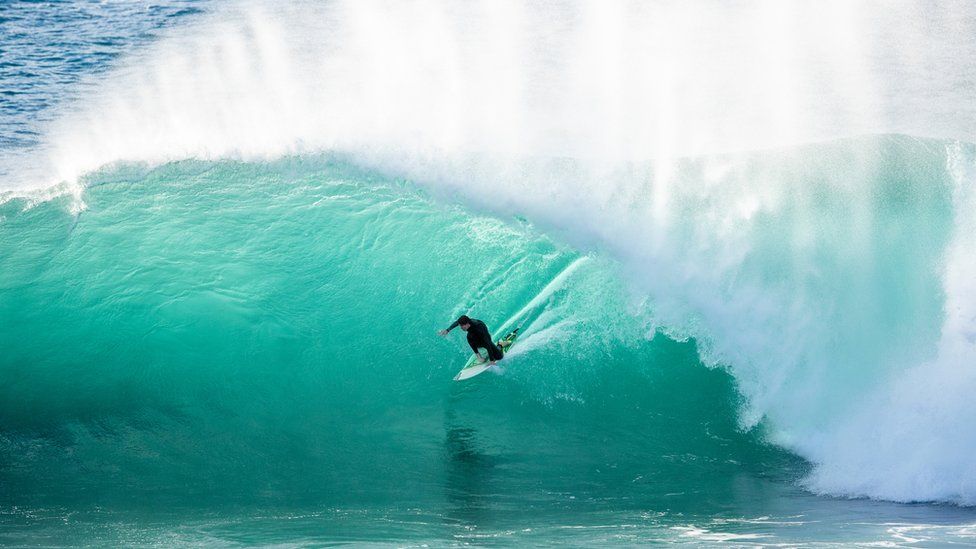 A surfer on a big wave in Sydney