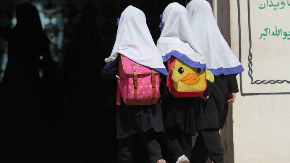 Three young girls walking together in Afghanistan
