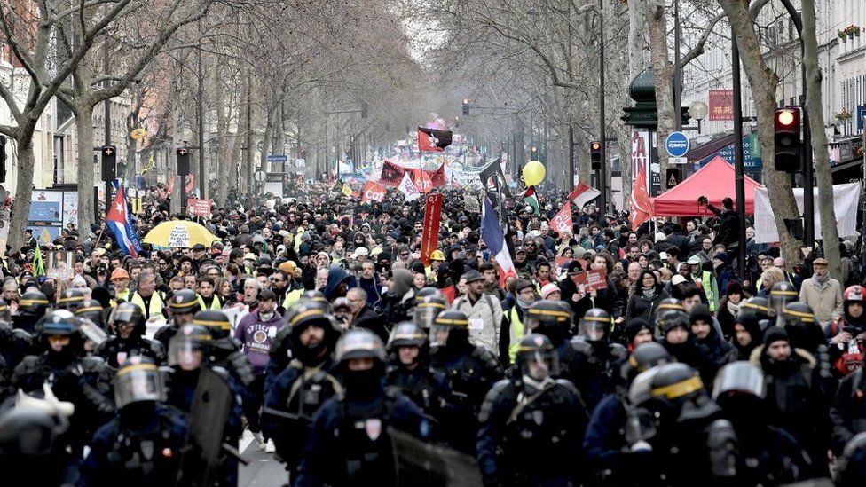 French anti-riot policemen lead the march as protesters demonstrate in Paris, on January 11, 2020