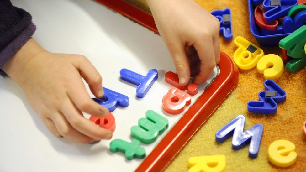 Child playing with plastic letters