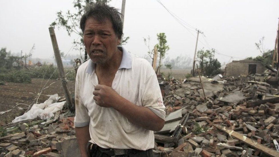 A villager stands near destroyed houses in China's Jiangsu province. Photo: 23 June 2016
