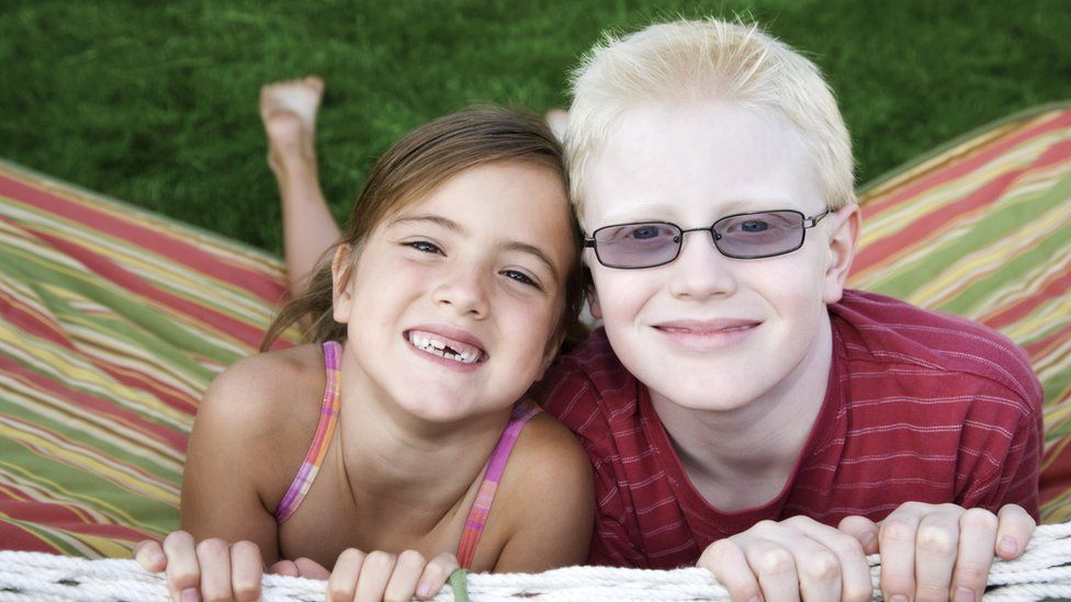 A boy with albinism with his sister
