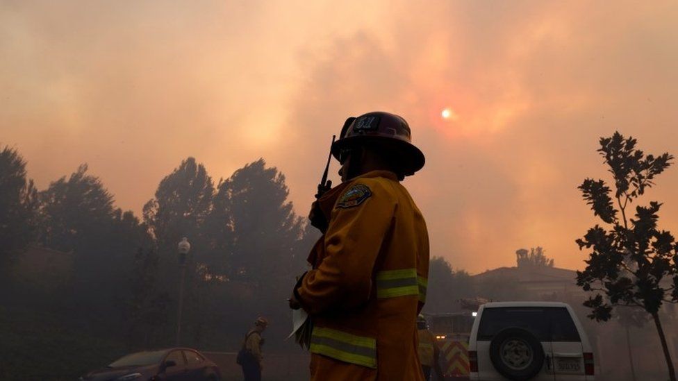 Firefighters gather as the Silverado Fire approaches, near Irvine, California