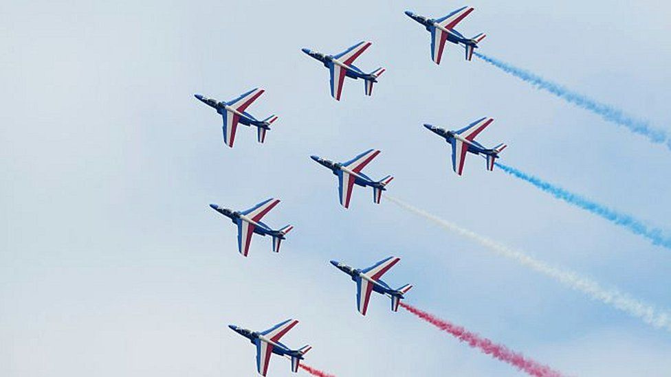 Alphajet aircrafts of the French elite acrobatic flying team 'Patrouille de France' (PAF) release smoke in the colours of the French national flag as they perform a flying display during the public days of the 51st International Paris Air Show in Le Bourget, north of Paris, on June 20, 2015