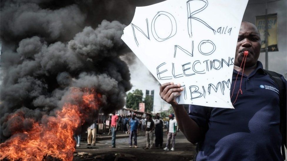 An opposition supporter holds a placard during a protest against Independent Electoral and Boundaries Commission (IEBC) in Kisumu, Kenya, on 11 October 2017
