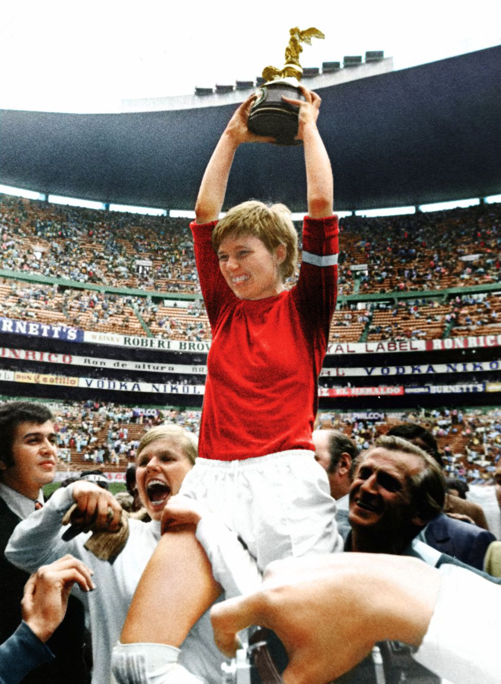 One of the victorious Denmark team holds the trophy in the Azteca Stadium in 1971