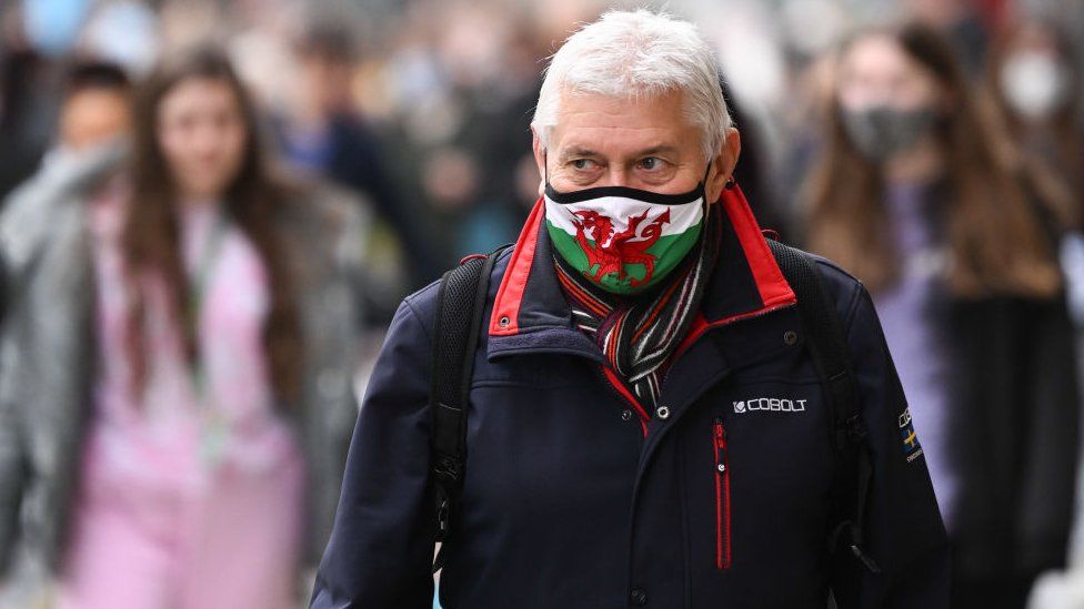 Man wearing Welsh flag face mask