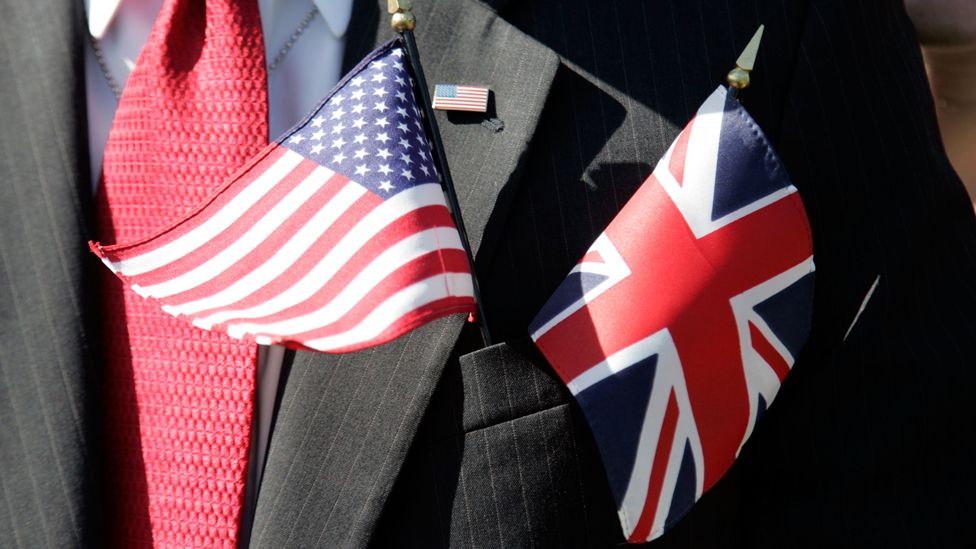 Generic image featuring a man with British and US flags in his suit pocket