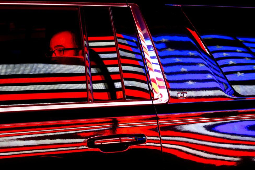 The US flag is reflected in a taxi window during the 100th New York Veterans' Day Parade.