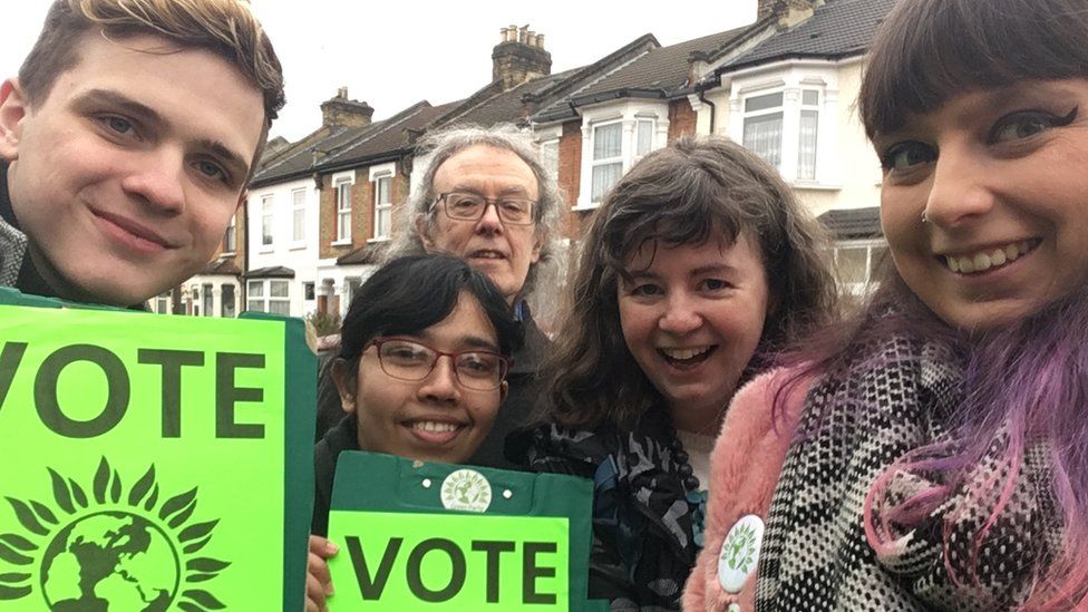 Frankie-Rose Taylor, right, and a group of campaigners holding 'vote Green' placards