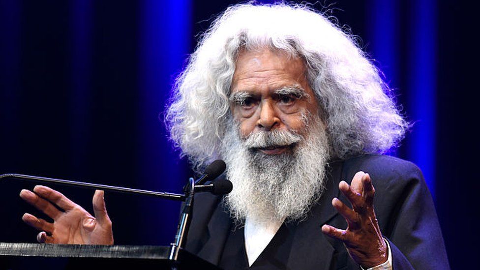 Uncle Jack Charles stands at a lectern