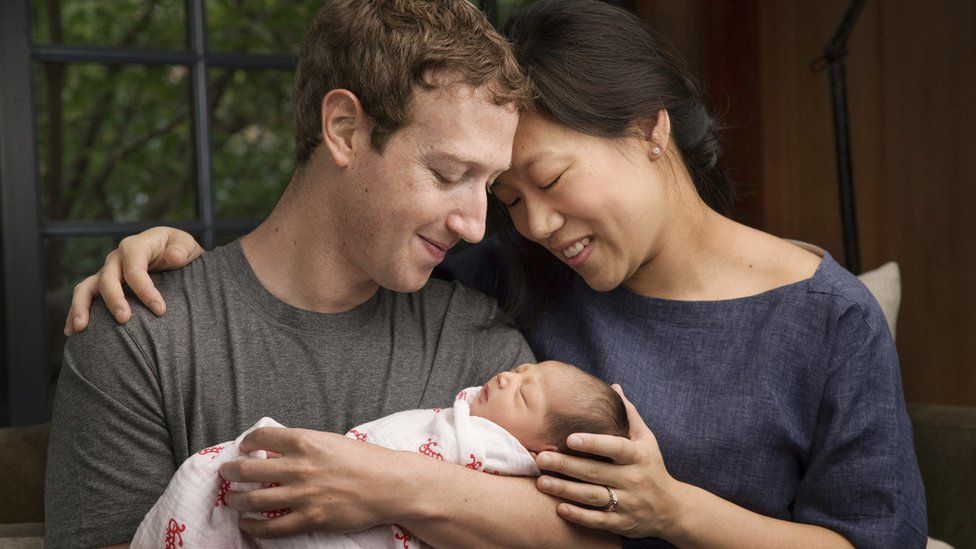 Baby Max Chan Zuckerberg is held by her parents, Mark Zuckerberg and Priscilla Chan Zuckerberg
