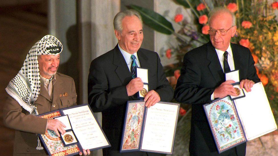 Palestinian leader Yasser Arafat, then Israeli Foreign Minister Shimon Peres, and late Israeli Prime Minister Yitzhak Rabin as they pose with the Nobel Peace Prize, 1994.
