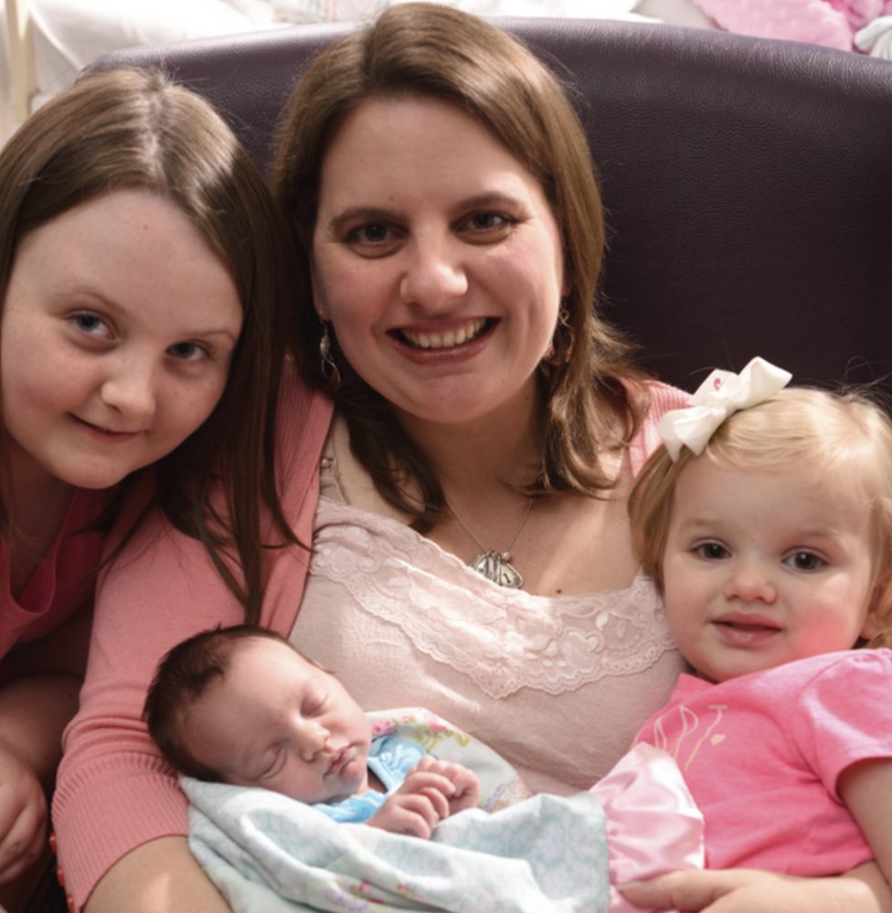 A picture showing Mrs Boemer with baby Lynlee and her two older daughters