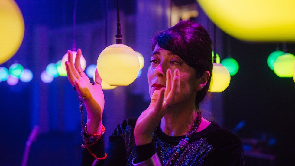 Woman looking at an light installation