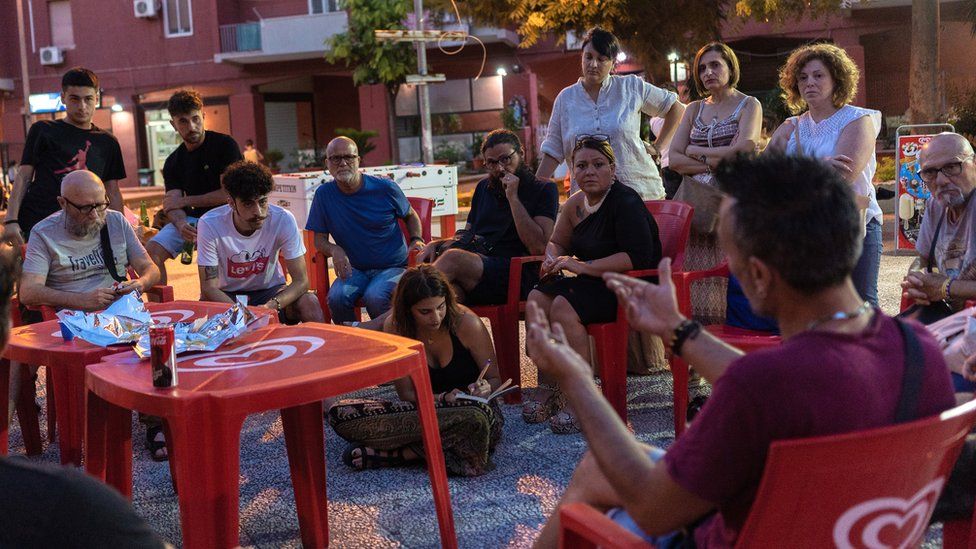 Community groups meet in the Tamburi neighbourhood of Taranto to discuss the closure of two schools