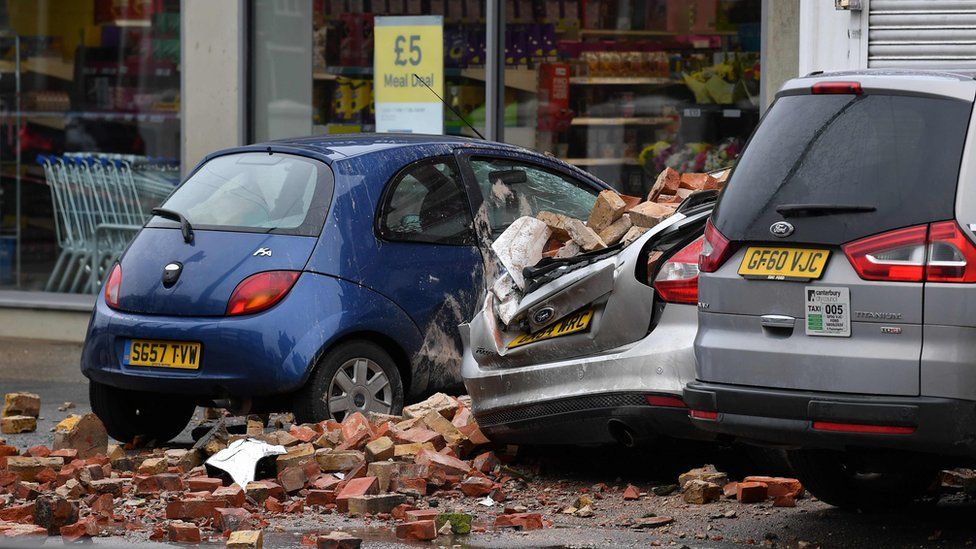 Bricks and debris cover damaged cars after part of a building collapsed in Herne Bay, Kent
