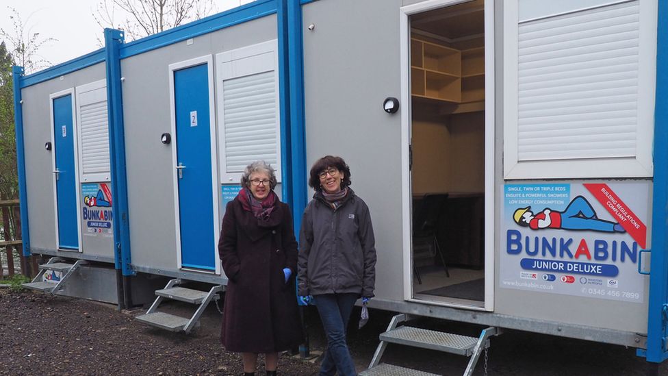 Volunteers Mary and Jackie beside the emergency accommodation