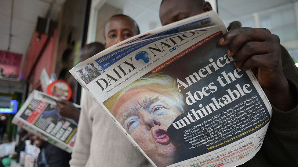People read a Kenyan daily newspaper with the front page showing newly elected US President Donald Trump in Nairobi on November 10, 2016