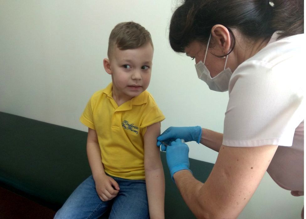 A boy being vaccinated in Lviv