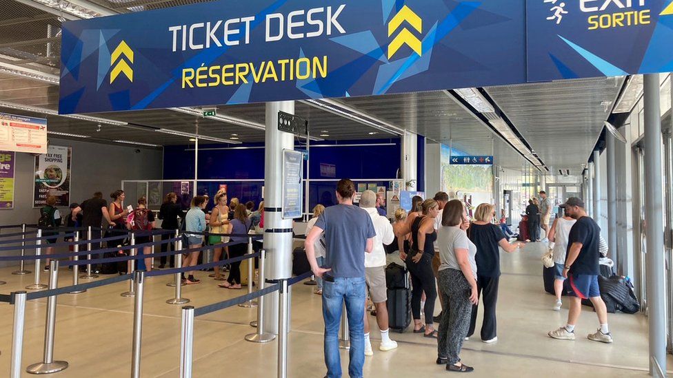 Passengers queue for information at Bergerac Dordogne Perigord Airport