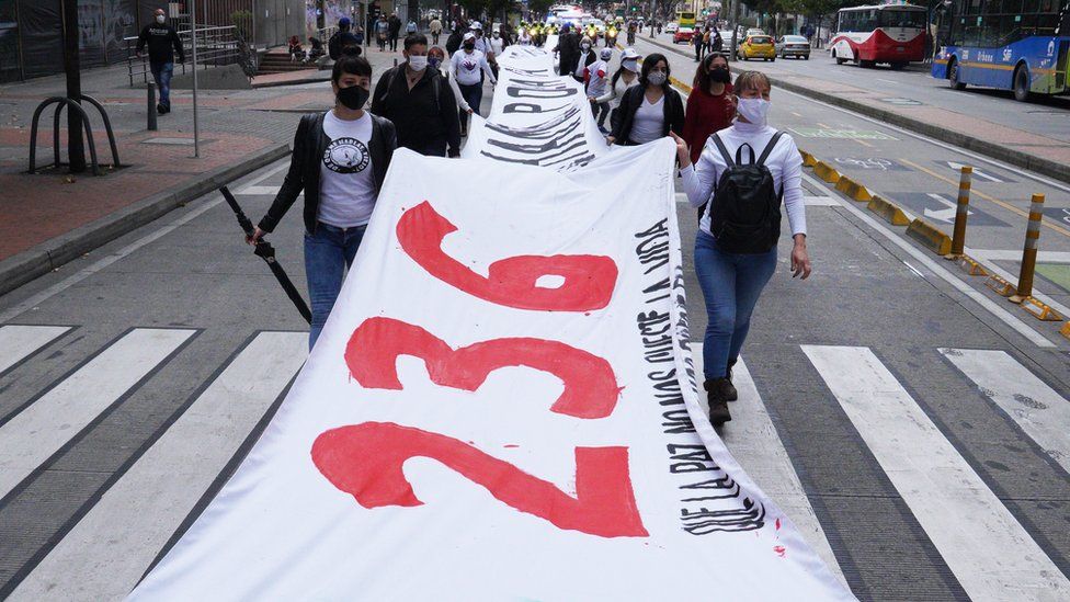 Activists marching through Bogota carry a banner that shows the number of former FARC fighters that have been murdered since the guerrilla group signed a peace deal with the government in 2016.