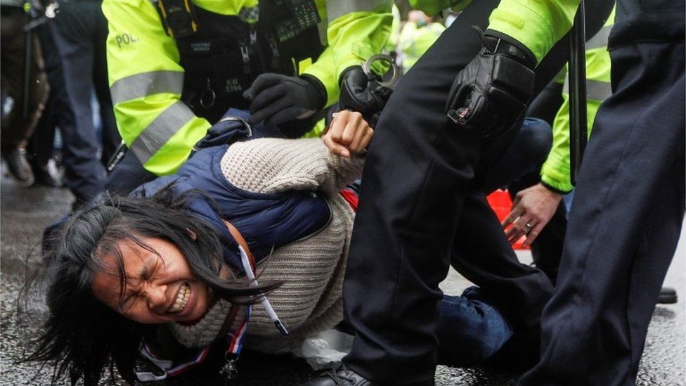 An anti-lockdown protester is arrested by police officers
