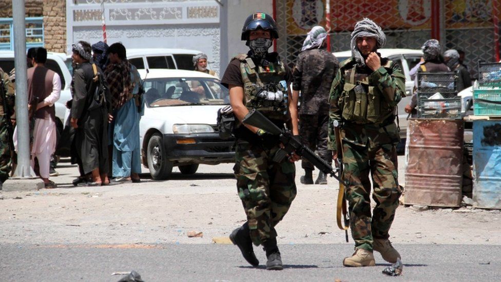 Afghan security officials patrol after they took back control of parts of Herat city