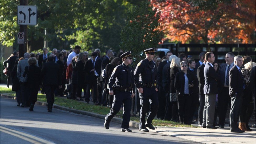 A long line has formed outside the Rodef Shalom Congregation ahead of the first funeral service for the victims
