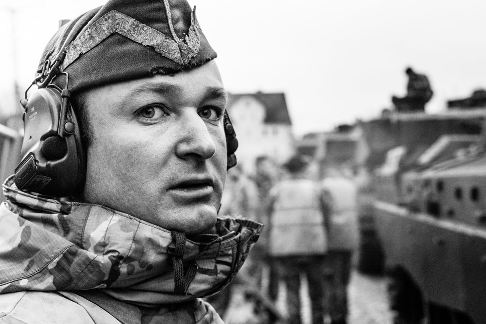 C Squadron leader of The Queen's Royal Hussars supervising loading of his tanks on to railway flats at Sennelager railhead, Germany, 2019