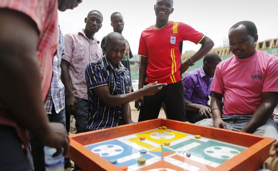 Men playing a board game in Kampala, Uganda - Saturday 20 February 2016