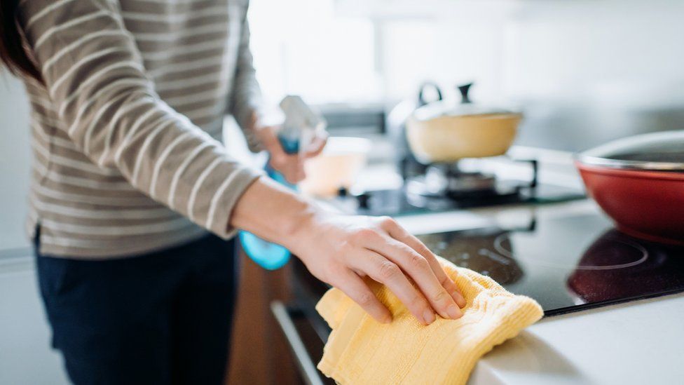Woman cleaning stove