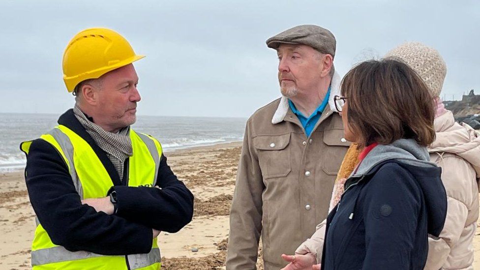 Steve Reed on the beach speaking to members of Save Hemsby Coastline