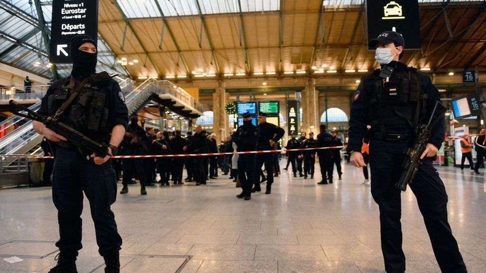Two armed guards stand near where the attack took place in Paris' Gare du Nord