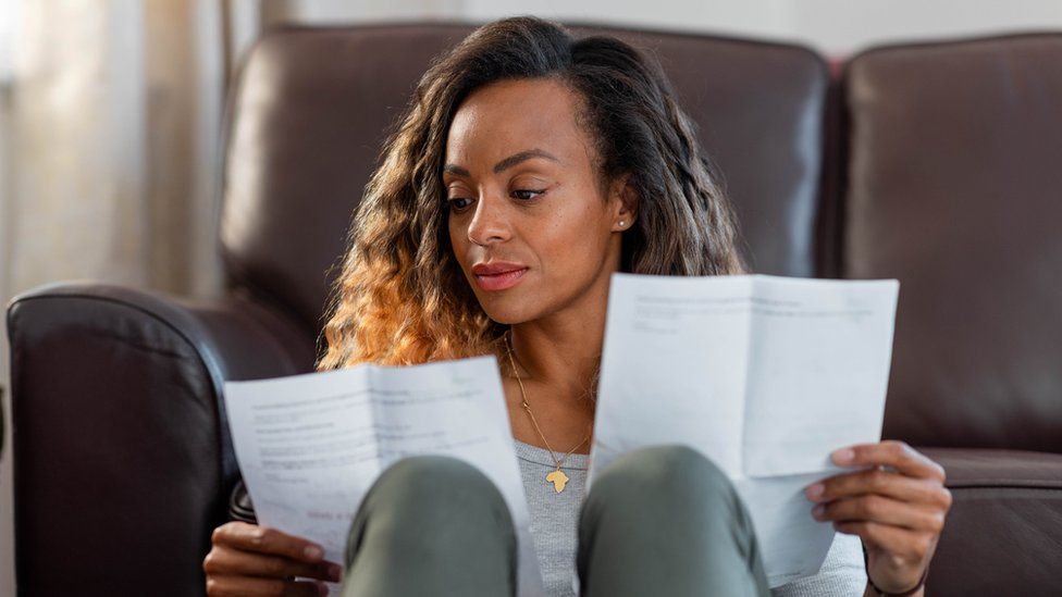 Woman looking astatine  bills