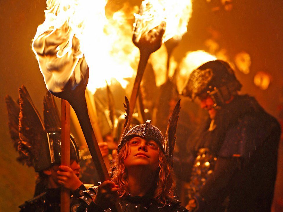 Members of the Junior Jarl Squad carry flaming torches