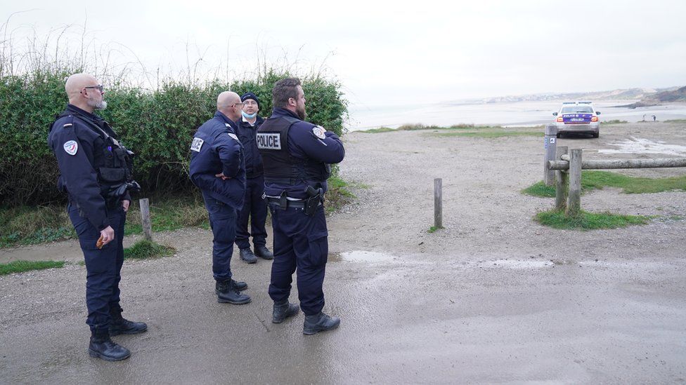 French police look out over the Channel