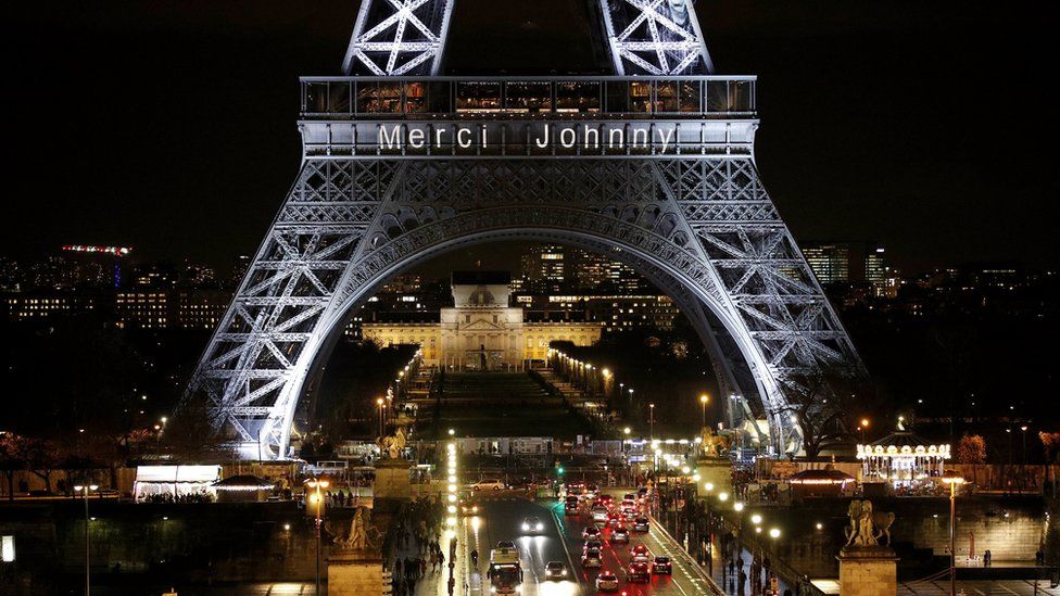 The Eiffel Tower in Paris is illuminated with the message "Merci Johnny" (Thank you Johnny) in memory of Johnny Hallyday, 8 December 2017