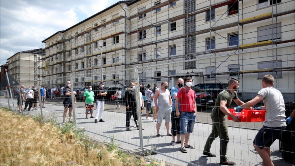 Authorities hand out food supplies to quarantined employees of the Tönnies meatpacking plant