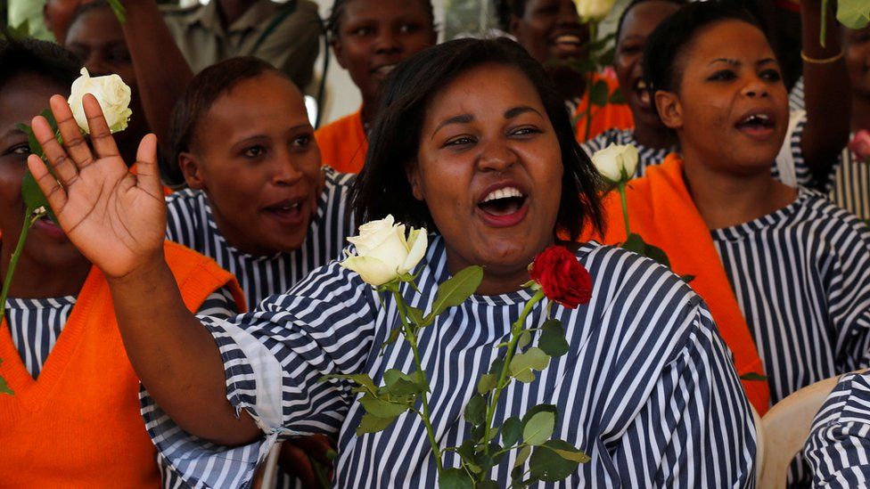 Cheering inmates holding flowers at Langata prison, Nairobi, Kenya - Tuesday 14 February 2017