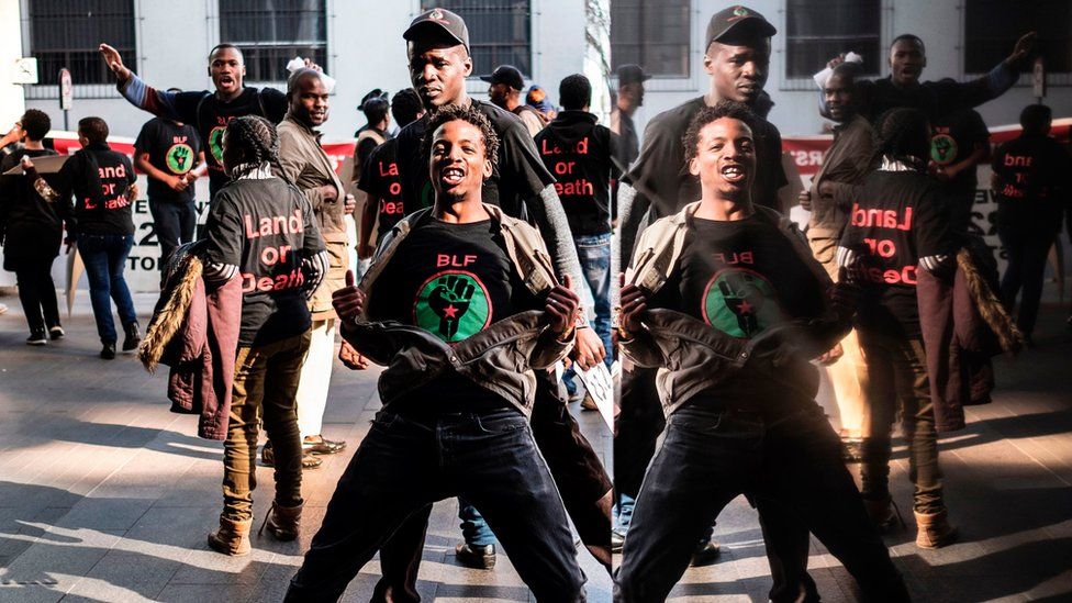 Members of Black First Land First (BLF) movement demonstrate outside an Absa Bank branch in downtown Johannesburg, on June 28, 201