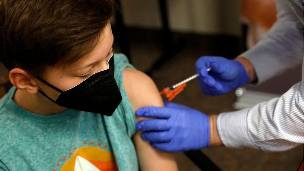 A teenage boy is vaccinated in the US with a Pfizer vaccine, which has been authorised for use in 12-15 year olds there