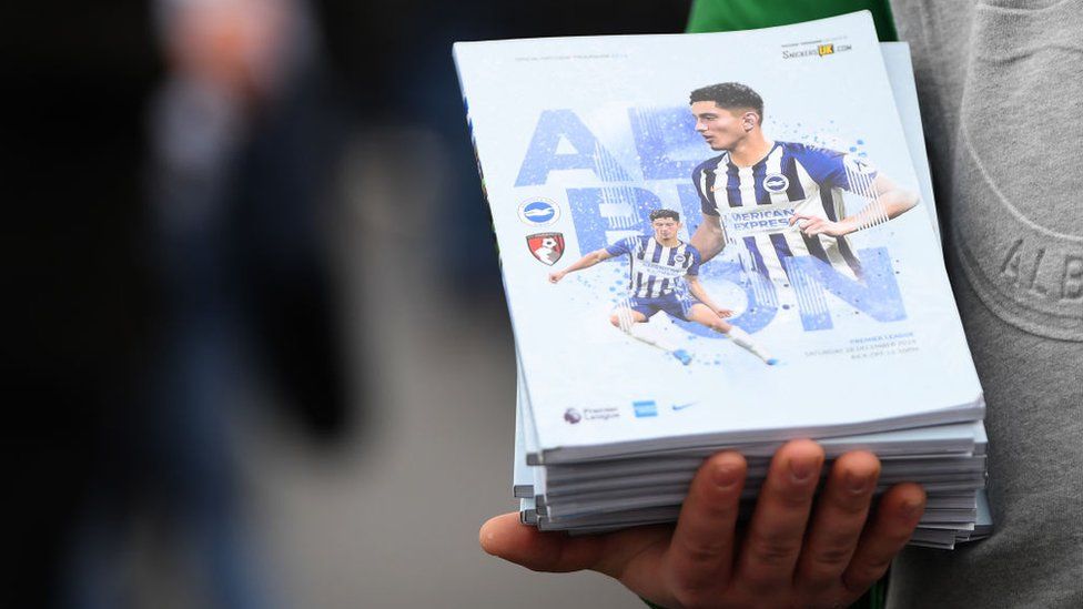 Football programmes for sale outside of Brighton's American Express Community Stadium