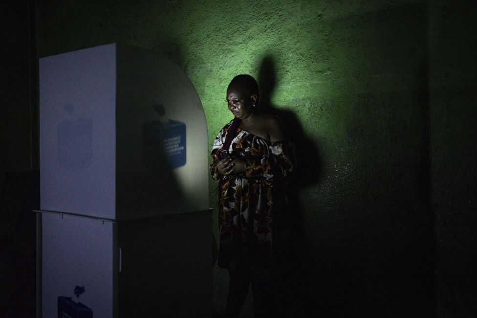 A voter marks her ballot at a polling station in Kinshasa, on December 20, 2023, as voting goes into the night after lengthy delays. Millions of Congolese head to the polls on December 20, 2023 in a high-stakes Democratic Republic of Congo general election in which President Felix Tshisekedi is seeking a new term against a fragmented opposition