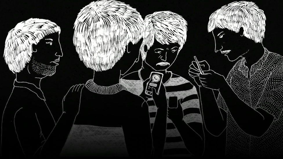 Men talking and looking at their mobile phones
