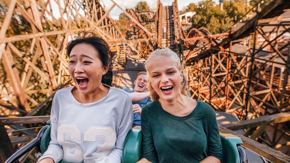 A stock image of riders on a rollercoaster