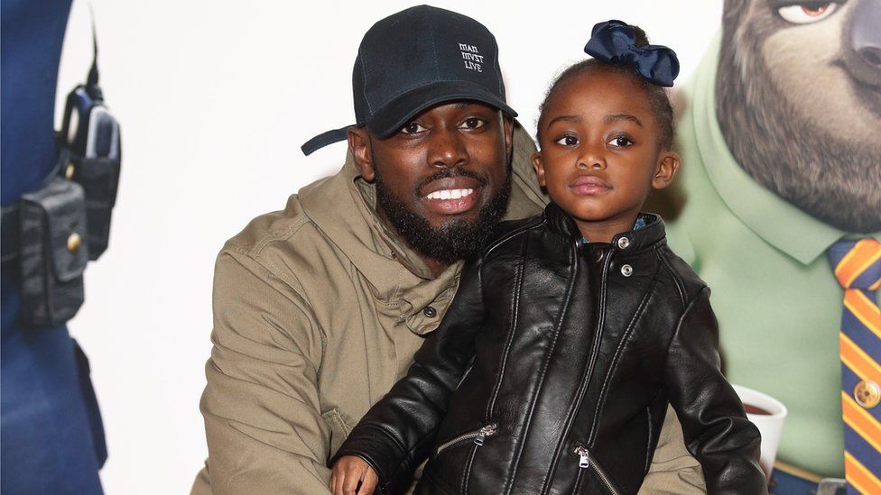 Ghetts with his daughter at the Zootropolis premiere